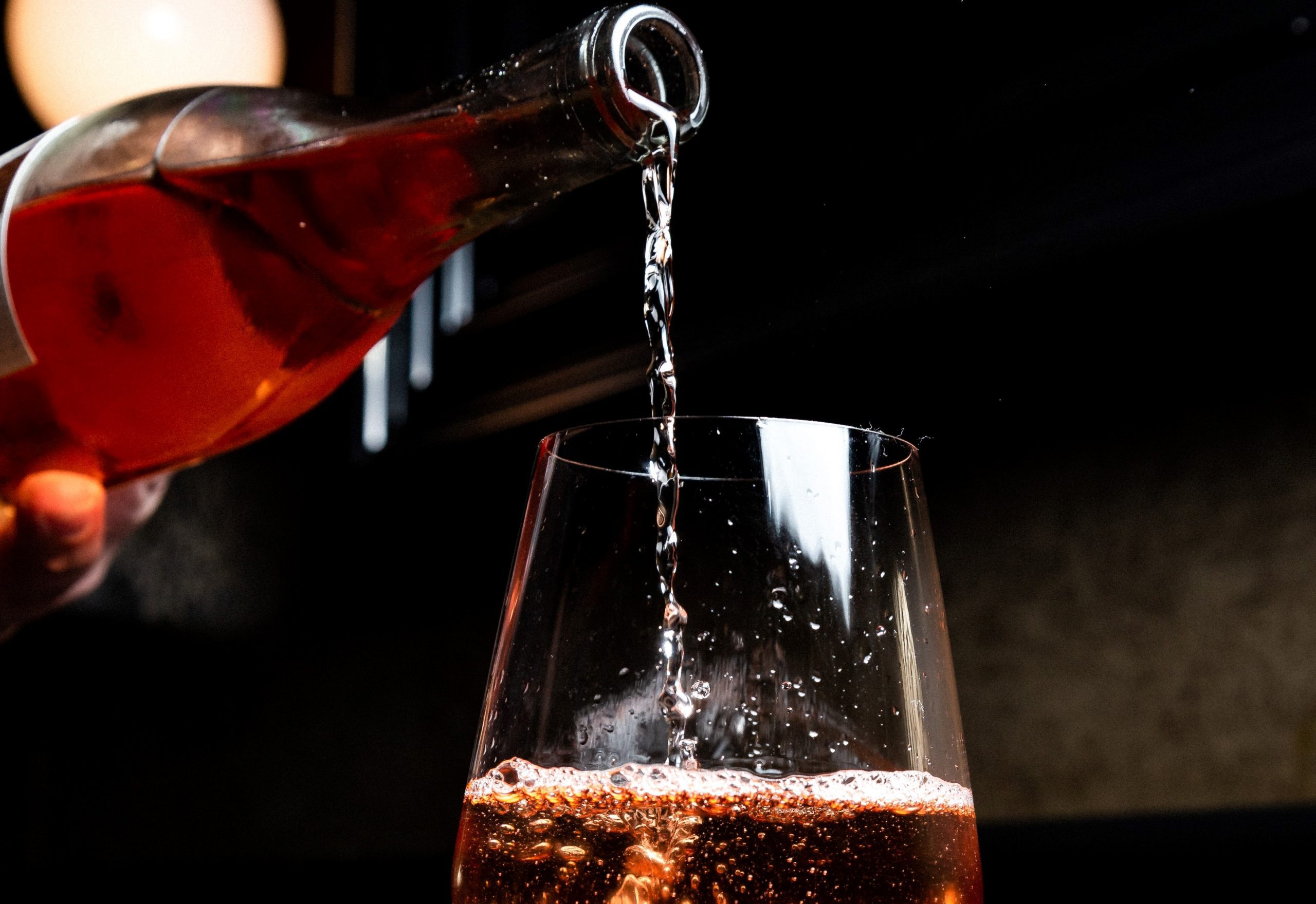 wine-from-bottle-poured-into-wine-glass