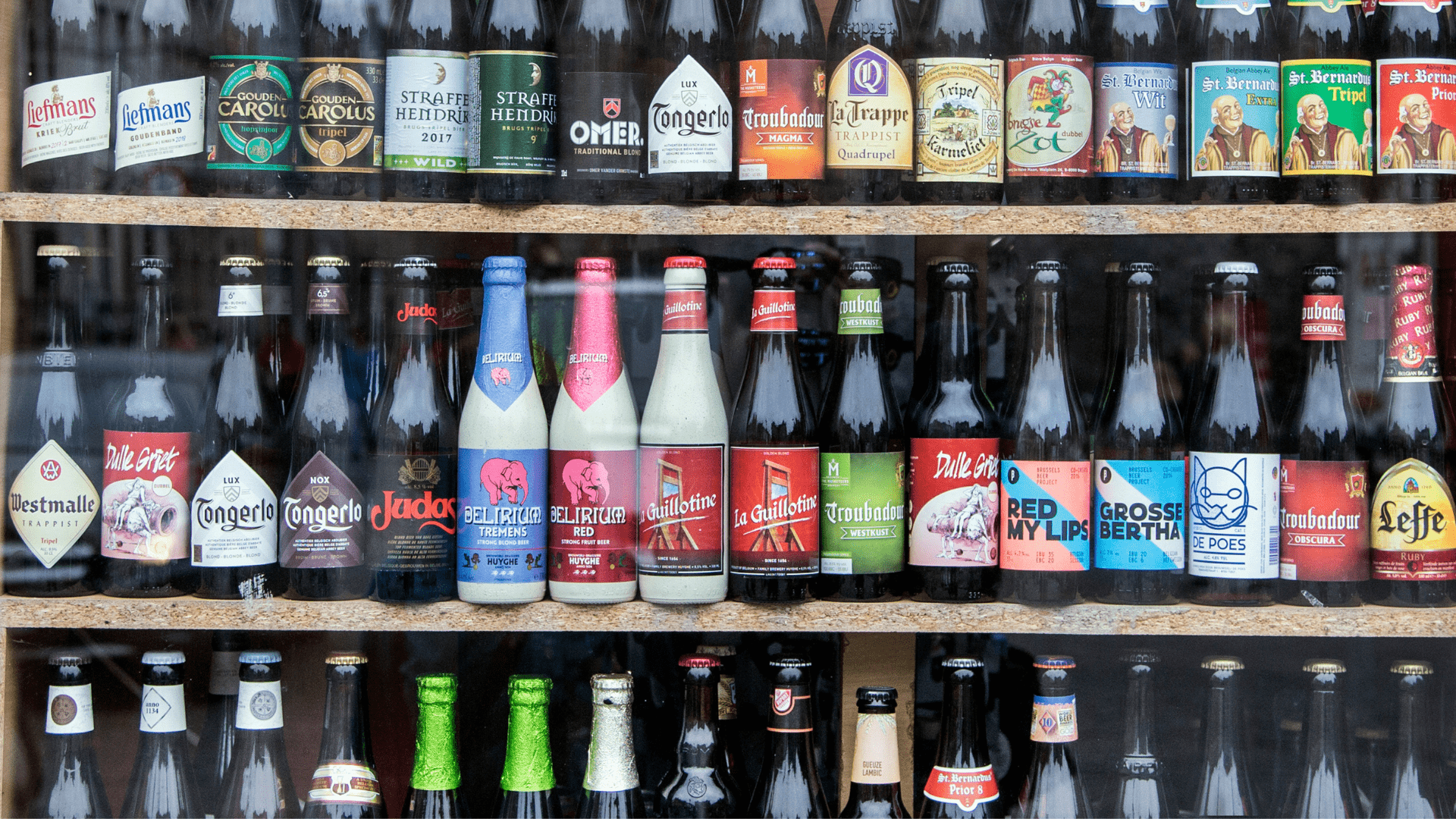 different beer bottles on shelves in store